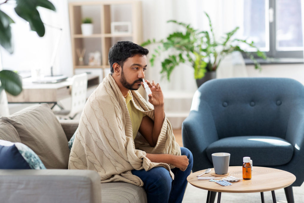 Man using nasal drug delivery device 