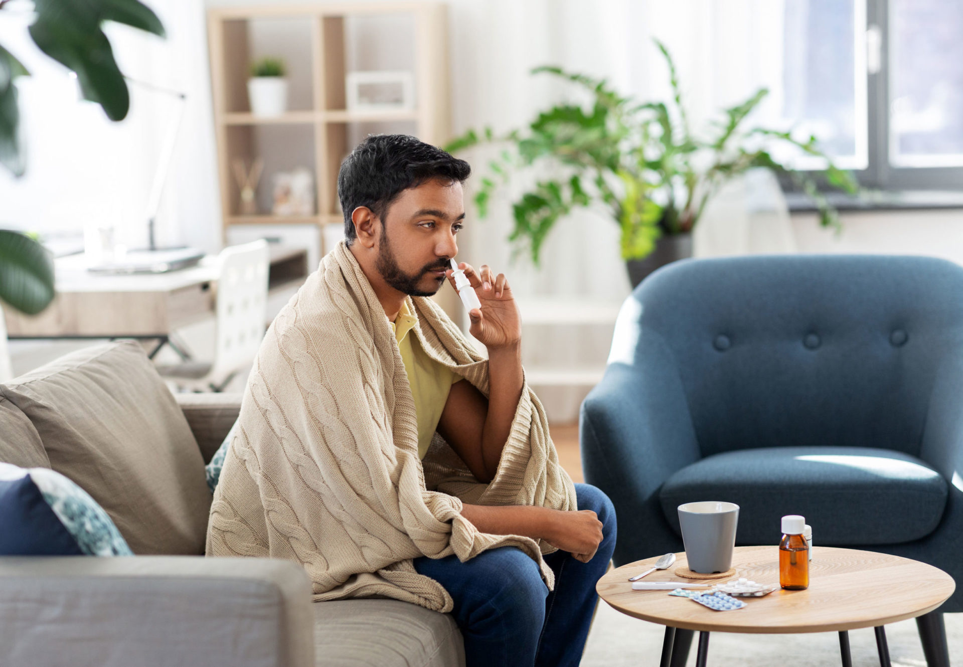 Man using aptar pharma nasal spray