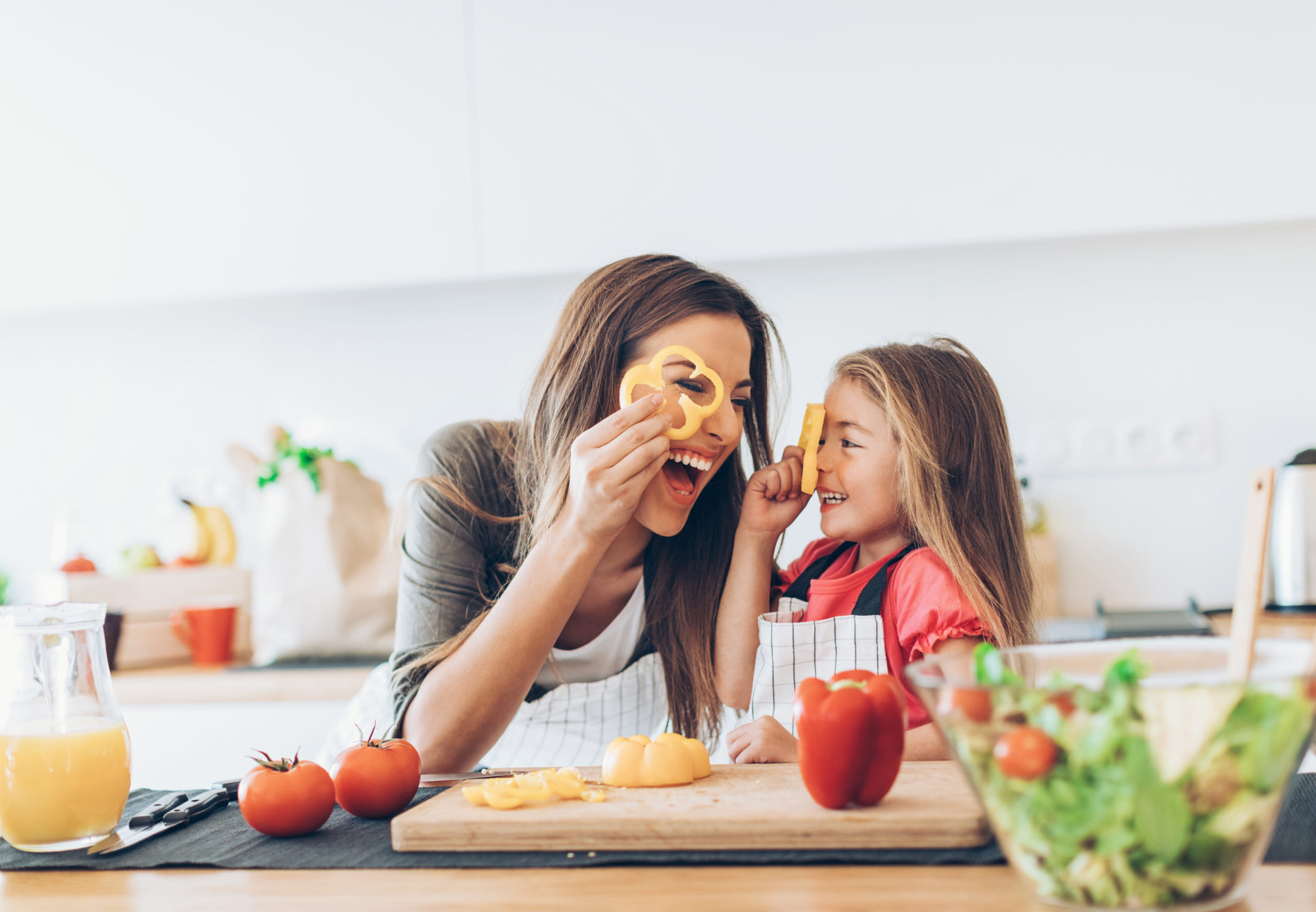 Mother and daughter preparing salad in the kitchen