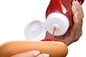 Valve dispensing ketchup on hot dog